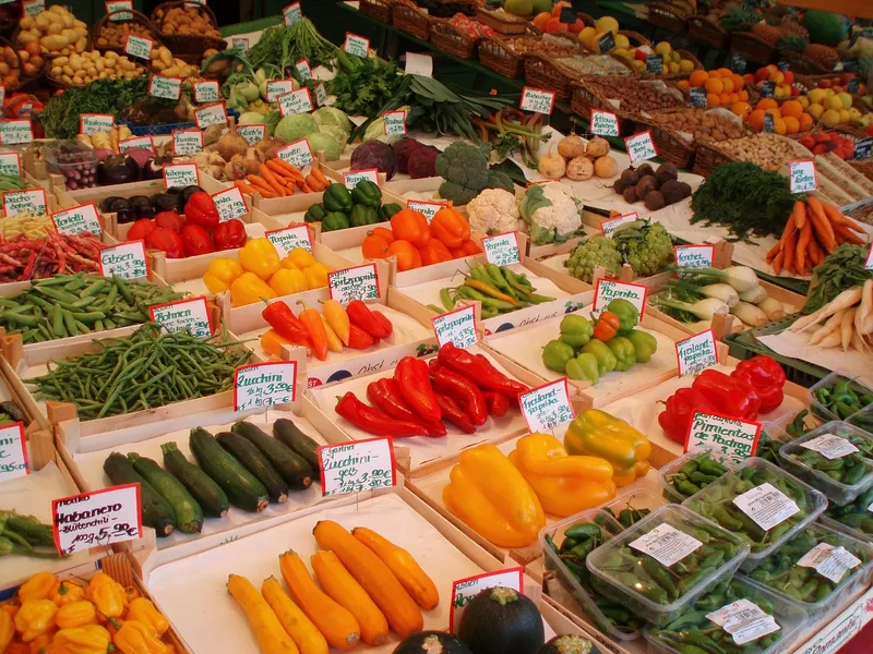 Puesto de verduras frescas en un mercado, ideal para elegir vegetales bajos en carbohidratos